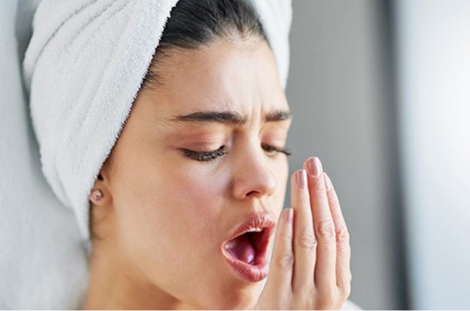 Woman smelling her breath