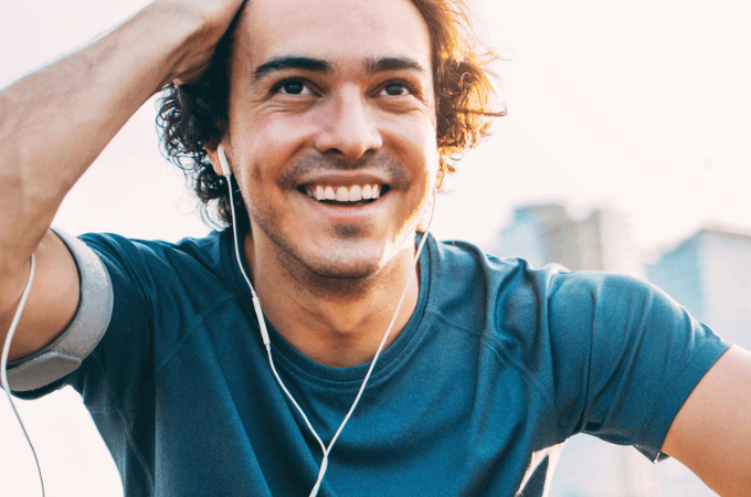 man smiling while listening to music