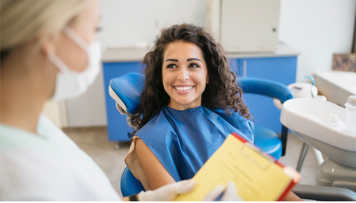 Woman patient at dentist's office smiling