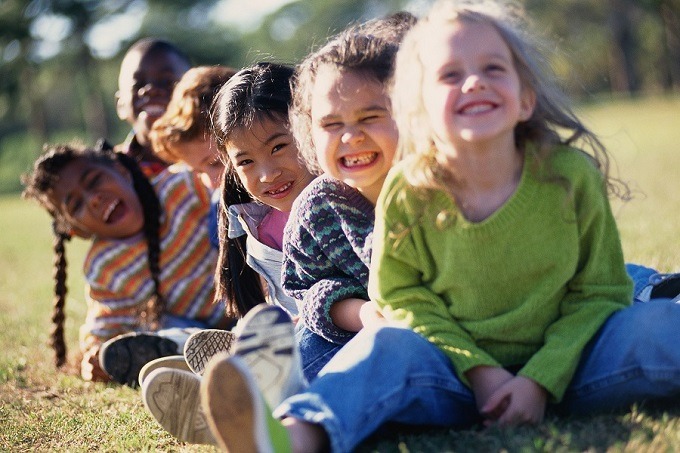 Mixed race children outside having fun