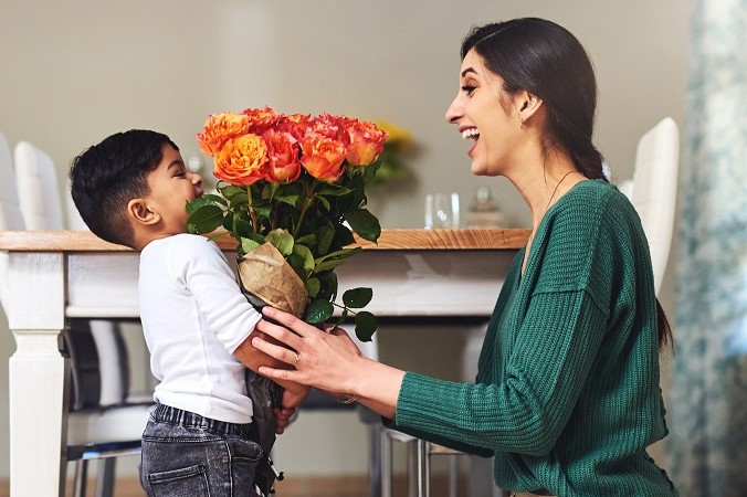 boy giving mother flowers