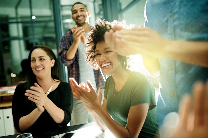 Mixed males and females laughing and clapping