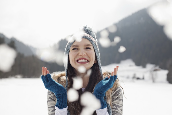 young, smiling white woman outside in the snow