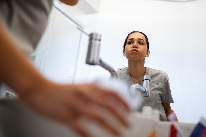 woman swishing with mouthwash