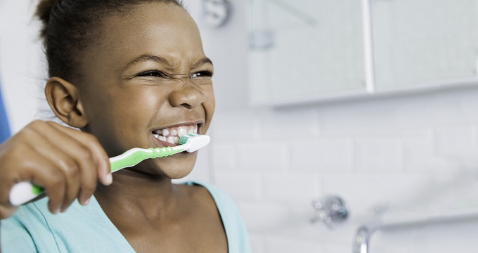 little girl brushing teeth