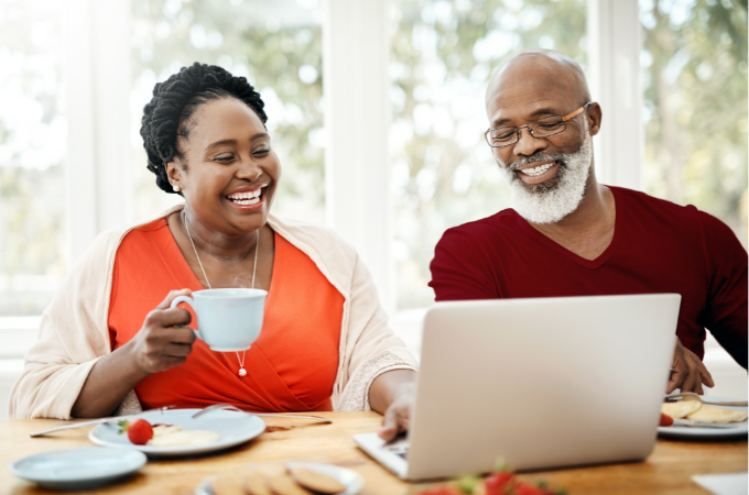 man and woman looking at computer