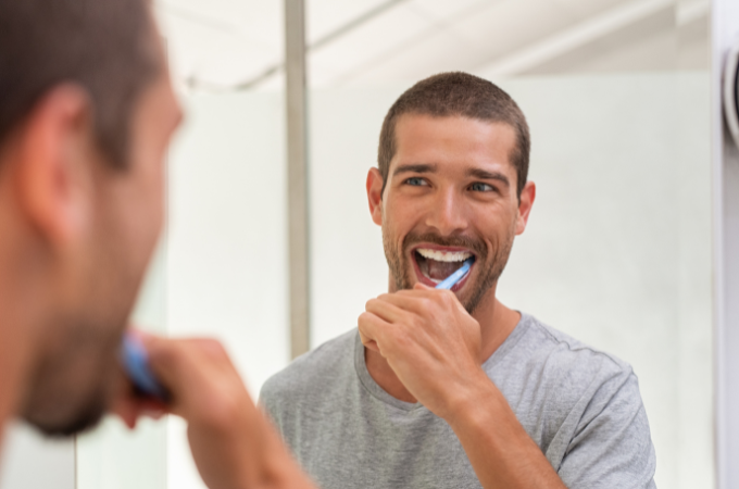 man brushing teeth