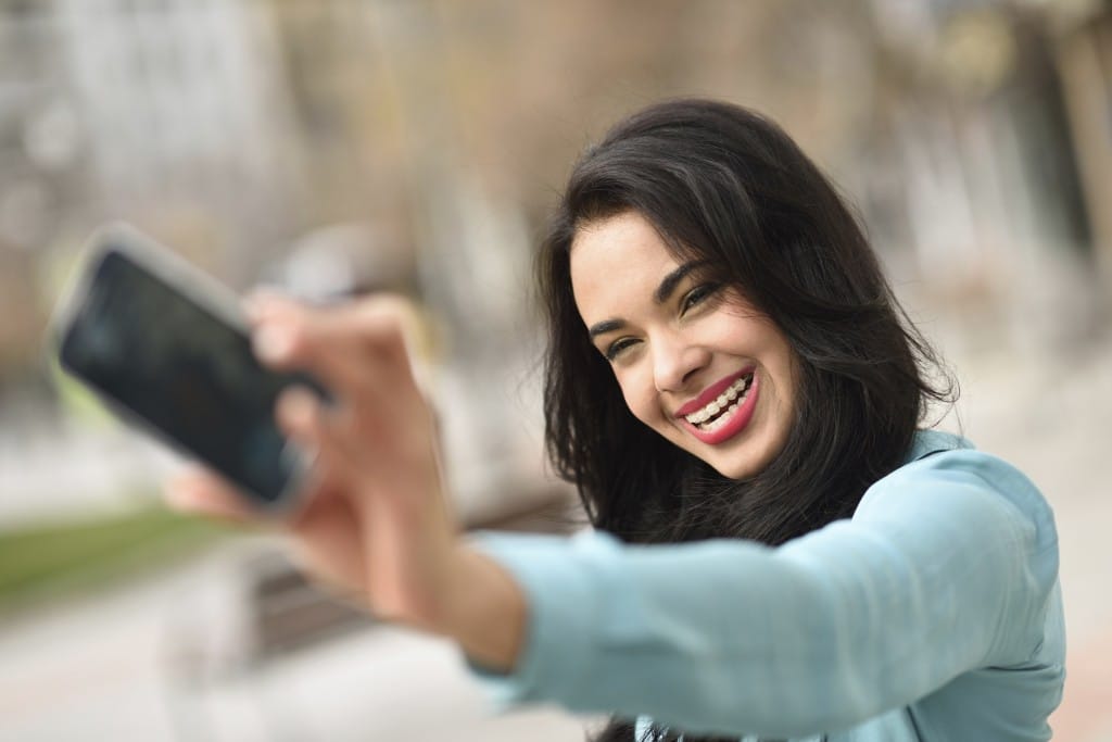 Beautiful young woman selfie in the park