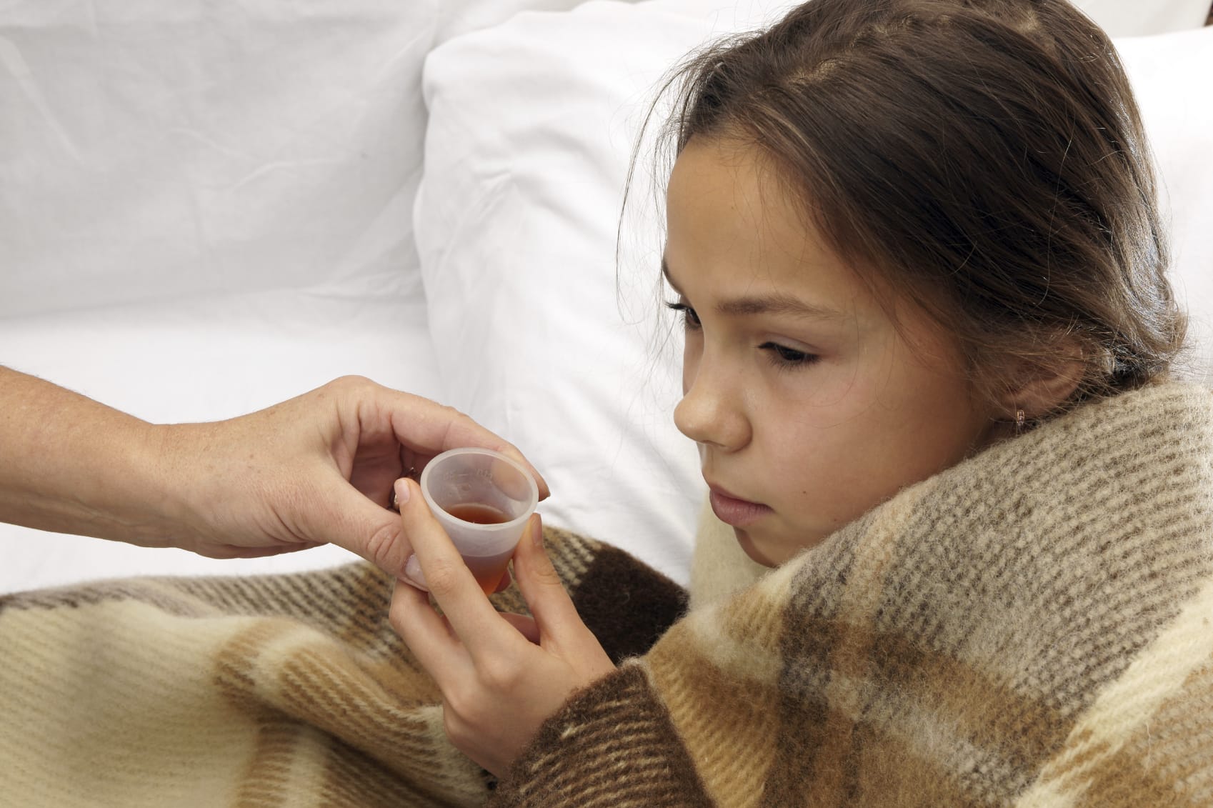 Girl takes medicine