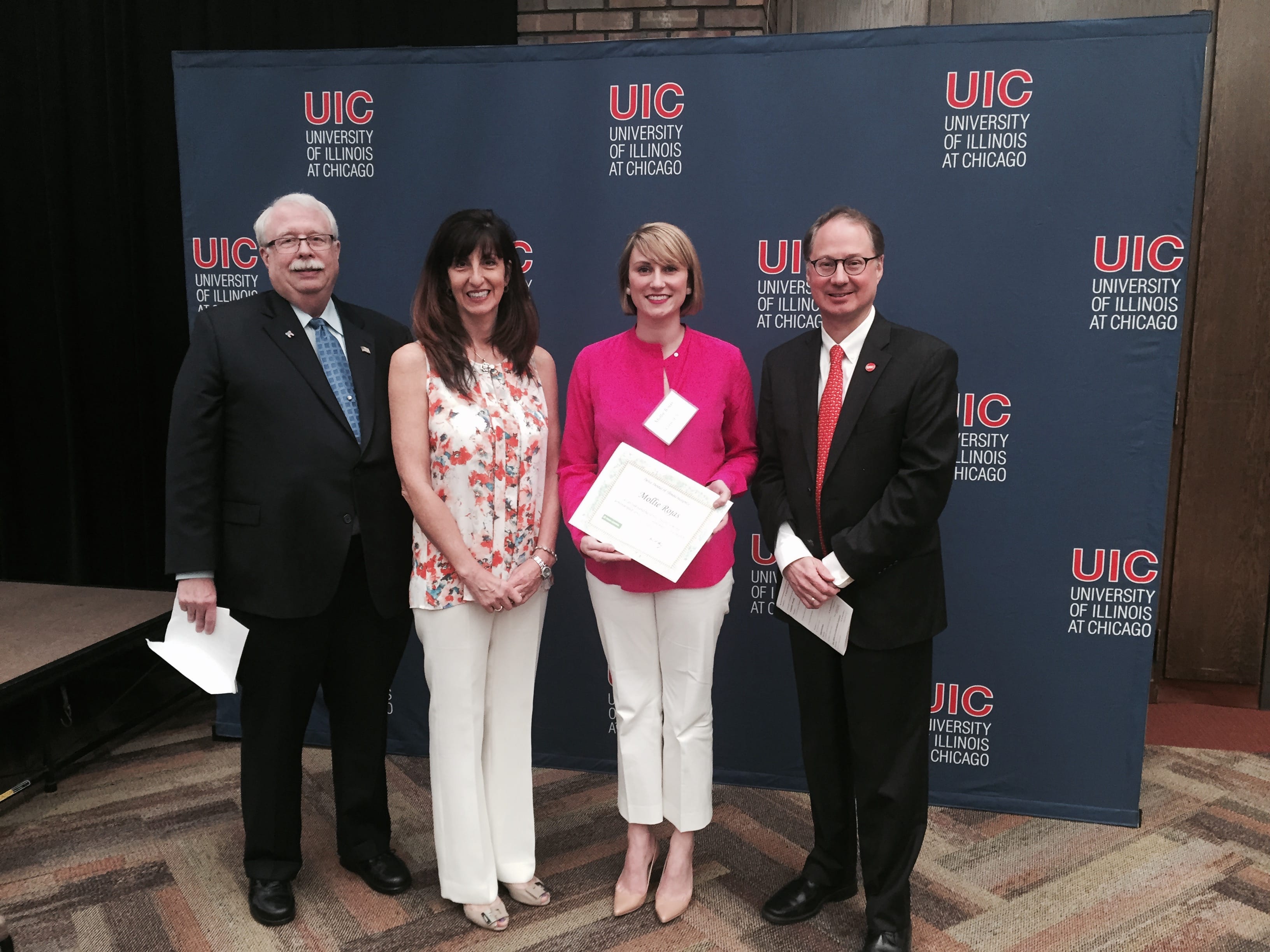 Delta Dental of Illinois Board members Craig Grannon and Nancy D. Cozzi, D.D.S., UIC dental student Mollie Rojas and UIC College of Dentistry Dean Dr. Clark Stanford